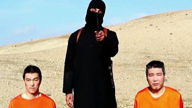Two men identified as Japanese nationals Kenji Goto, left, and Haruna Yukawa are seen on their knees in a video released Jan. 20, 2015, by the Islamic State of Iraq and Syria (ISIS) 