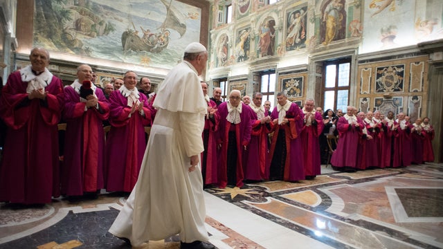Pope Francis (C) walks past prelate auditors, officials and advocates of the Tribunal of the Roman Rota during an audience for the occasion of the solemn inauguration of the judicial year at the Clementine Hall of the Vatican Apostolic Palace on Jan. 23,  