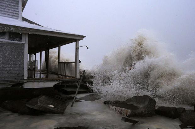 Waves crash against ocean front house after smashing through sea wall during blizzard in Marshfield, Massachusetts on January 27, 2015 