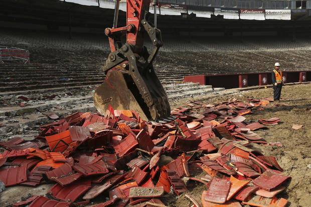 A worker stands near a stack of broken stadium seats at Candlestick Park in San Francisco, California, Feb. 4, 2015. 