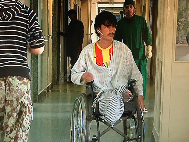 Nasibullah, an Afghan Army soldier who lost both legs to an IED, rolls around a military hospital in Kabul 
