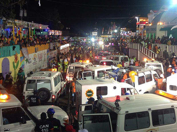 Emergency service vehicles and personnel attend the scene of a fatal accident during a Carnival float procession in Port-au-Prince 