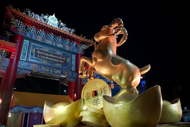A golden statue of a goat is displayed for the upcoming Lunar New Year in the Chinatown area of Bangkok on Feb. 18, 2015. 