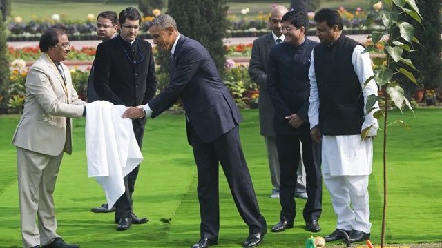 President Obama wipes his hands after participating in a tree planting ceremony at Raj Ghat, the Mahatma Gandhi Memo. 25, 2015.  