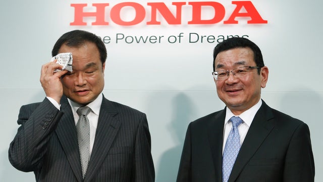 Honda Motor Co's incoming President and Chief Executive Officer Takahiro Hachigo (R) and outgoing President and CEO Takanobu Ito attend a news conference at the company's headquarters in Tokyo Feb 23, 2015. 