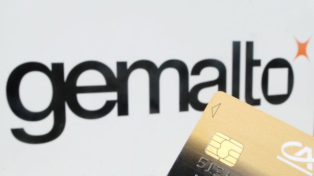 Dutch SIM card maker Gemalto's logo seen behind a SIM card embedded in a debit card 