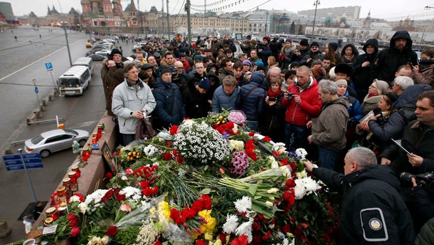 People gather at the site where Boris Nemtsov was recently murdered with St. Basil's Cathedral seen in the background in central Moscow Feb. 28, 2015. 