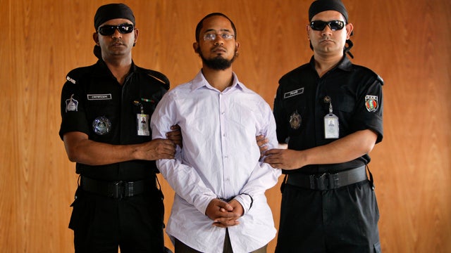 Members of Bangladesh's Rapid Action Battalion (RAB) force escort Farabi Shafiur Rahman, a suspect in the murder of American blogger Avijit Roy 