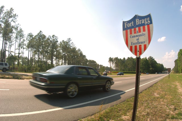 Cars pass by a community sign for Fort Bragg May 13, 2004, in Fayettville, North Carolina.