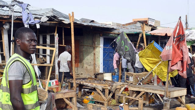 Rescuers arrive at the scene of a blast where a suspected Boko Haram female suicide bomber blew herself up at the crowded market in Maiduguri 