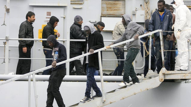 Migrants disembark from a ship, Feb. 17, 2015, in Porto Empedocle, southern Sicily, following a rescue operation by the International Frontex plan (Triton) 