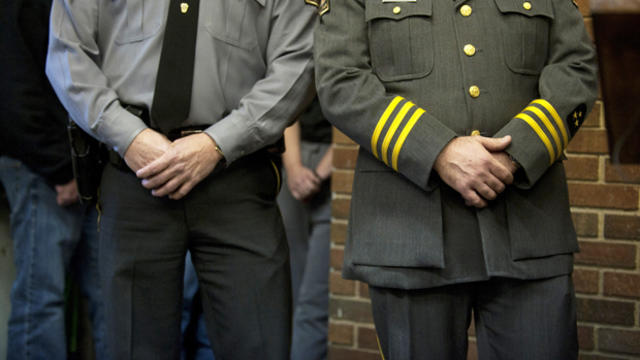 Pennsylvania State Police troopers listen as spokesman Lt. Col. George Bivens describes the scene of a shooting in Blair County Dec. 21, 2012, in Geeseytown, Hollidaysburg, Pennsylvania. 