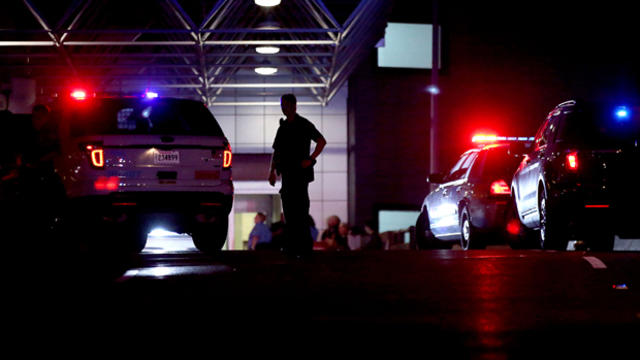 An officer directs traffic at the entrance to New Orleans International Airport March 20, 2015, in Kenner, La. 