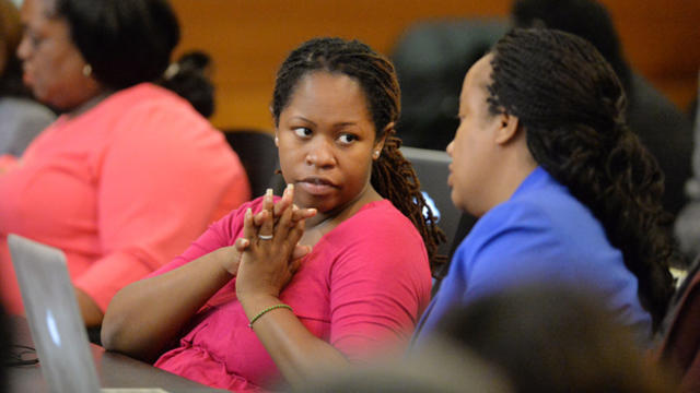 Former Dunbar Elementary teacher Shani Robinson, left, and her defense attorney, Annette Greene, talk in Fulton County Superior Court March 19, 2015, in Atlanta. 