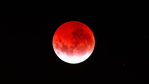 A blood red moon lights up the sky during a total lunar eclipse April 4, 2015, in Auckland, New Zealand. 