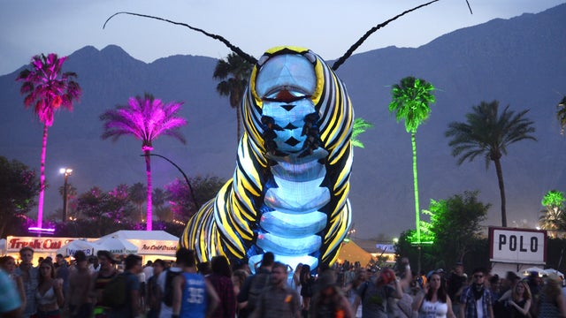 A giant caterpillar moves through the crowd on the first day of the Coachella Music Festival in Indio, California, April 10, 2015. 