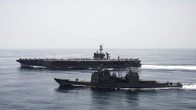 The aircraft carrier USS Theodore Roosevelt (CVN 71) and the guided-missile cruiser USS Normandy (CG 60) operate in the Arabian Sea 