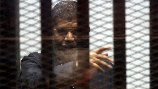 Ousted Egyptian President Mohammed Morsi is seen behind bars during his trial at a court in Cairo April 30, 2015. 