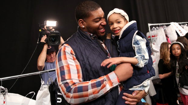 NFL player Devon Still and daughter Leah prepare backstage at the Nike Levi's Kids fashion show during Mercedes-Benz Fashion Week Fall 2015 at The Salon at Lincoln Center Feb. 12, 2015, in New York City. 