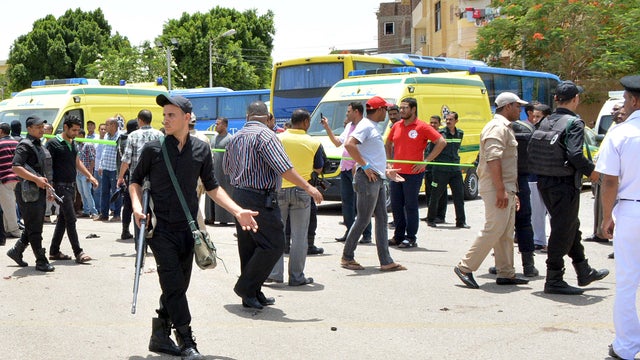 Police and people stand near the scene of a foiled suicide attack near the Karnak temple in Luxor, Egypt 