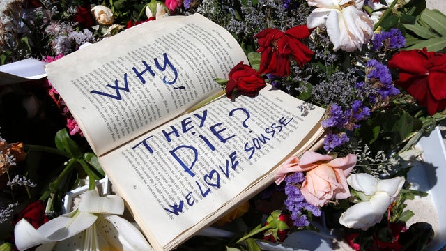 A book and flowers lay at the scene of the attack in Sousse, Tunisia, June 28, 2015. 
