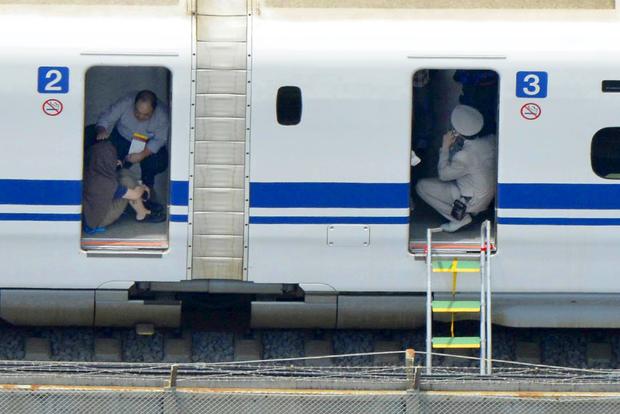 Passengers are seen inside a Shinkansen bullet train after it made an emergency stop in Odawara, south of Tokyo 