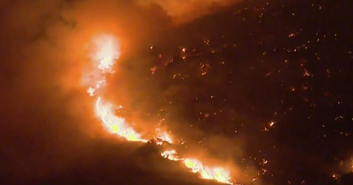 Fast-moving wildfire sparked in Southern California - CBS News