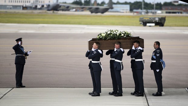 The coffin of Ann McQuire is carried from an RAF C-17, which repatriated the bodies of nine British nationals killed by a gunman in an attack at the Tunisian beach resort of Sousse, in RAF Brize Norton in Oxfordshire, Britain, July 2, 2015. 