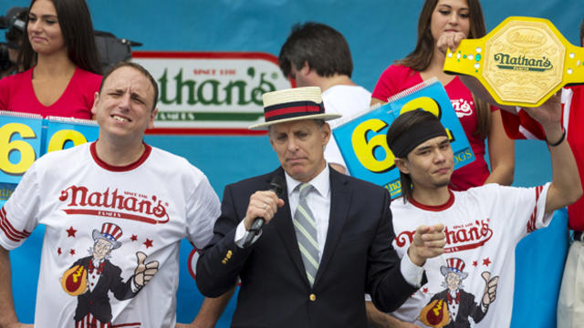 Matt Stonie, right, is crowned winner of the annual Fourth of July 2015 Nathan's Famous Hot Dog Eating Contest in Brooklyn, New York, July 4, 2015. 