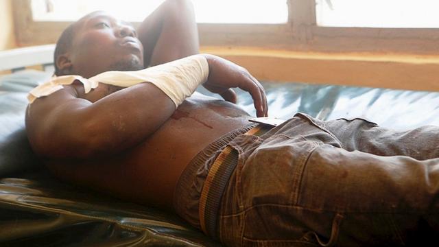 A man rests on a hospital bed as he awaits treatment after he was injured during an overnight attack on a residential complex in Soko Mbuzi village of Mandera town at the Kenya-Somalia border 