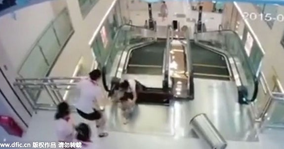 Chinese woman dies on escalator, but saves son - CBS News