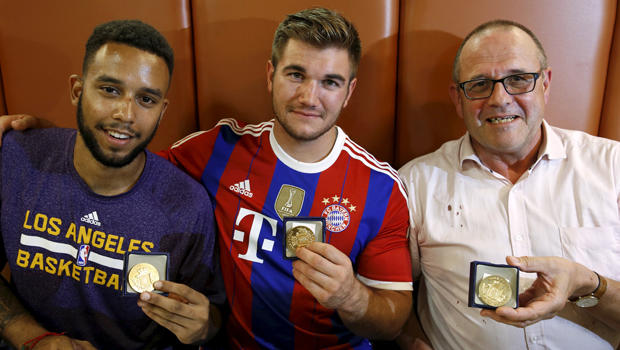 Three men who helped disarm an attacker on a train from Amsterdam to France, ​from left, Anthony Sadler, from Pittsburg, California, Aleck Sharlatos, from Roseburg, Oregon, and Chris Norman, a British man living in France, pose with medals they received f 