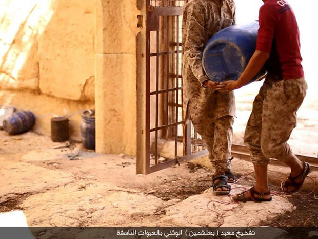 An image posted online by ISIS' branch in the Syrian province of Homs appears to show  militants planting explosives inside the ancient temple of Baalshamin 