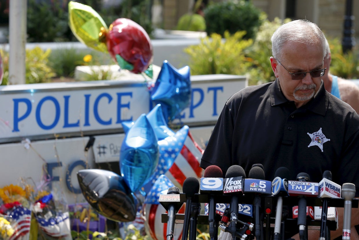 Somber holiday weekend amid manhunt for cop killers - CBS News