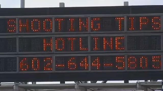 Highway sign is seen in Phoenix on September 9, 2015 uring people to call in tips as authorities pressed their investigation into a series of incidents on city highways in which windows of passing vehicles were shot out 