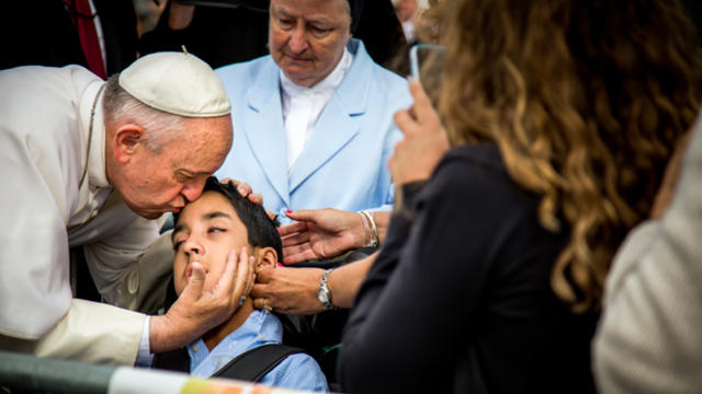 Pope Francis kisses and blesses Michael Keating, 10, of Elverson, Pa., after arriving in Philadelphia and exiting his car when he saw the boy Sept. 26, 2015, at Philadelphia International Airport in this photo provided by World Meeting of Families. 