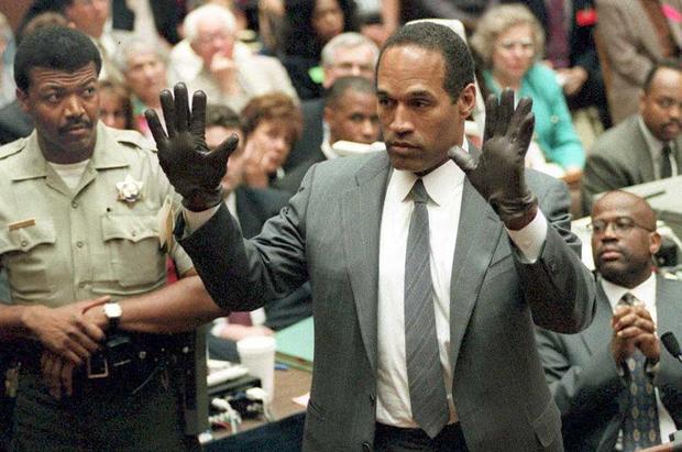O.J. Simpson tries on gloves allegedly used in the murders during the "Trial of the Century" 