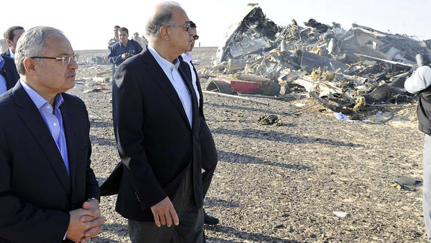 Egypt's Prime Minister Sherif Ismail, second left, and Tourism Minister Hisham Zaazou look at the remains of a Russian airliner which crashed in central Sinai near El Arish city, north Egypt, Oct. 31, 2015. 