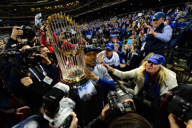 Kansas City Royals center fielder Jarrod Dyson hoists Commissioners Trophy after Royals defeated New York Mets in game 5 of the World Series at Citi Field in New York to win the Series, four-games-to-one 