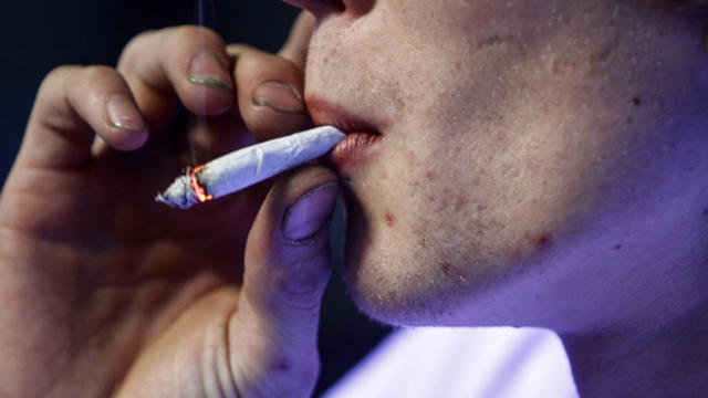 A customer smokes a marijuana and tobacco joint at Frankie's Sports Bar and Grill in Olympia, Washington, Dec. 9, 2012. 