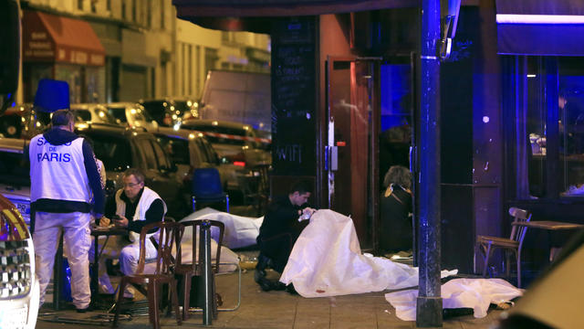 Victims lay on the pavement in a Paris restaurant Nov. 13, 2015. Police officials in France reported a shootout in a Paris restaurant and an explosion in a bar near a Paris stadium. 