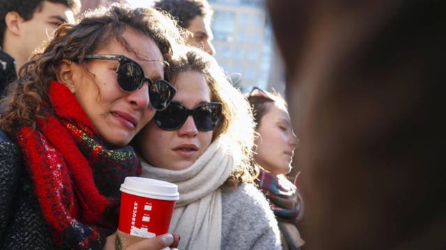 People console each other at a gathering in response to attacks in Paris, at Washington Square Park in the Manhattan borough of New York Nov. 14, 2015. 