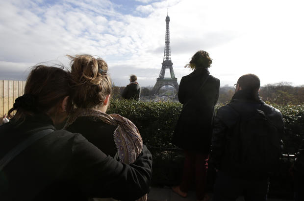 People observe a minute of silence at the Trocadero in front of the Eiffel Tower to pay tribute to the victims of the series of deadly attacks in Paris, France, Nov. 16, 2015. 