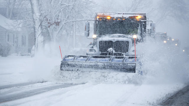 Snow is plowed from the street during a heavy snowy day Nov. 21, 2015, in Northbrook, Ill. 