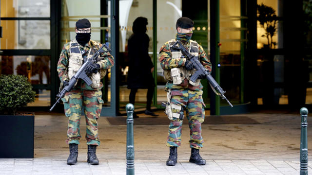 Belgian soldiers stand guard outside the Radisson Blu hotel in central Brussels Nov. 21, 2015, after security was tightened in Belgium following the fatal attacks in Paris. 