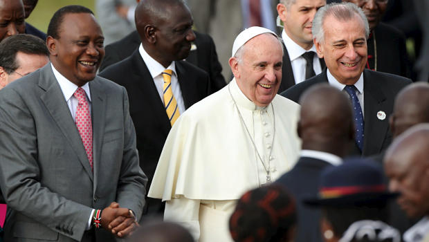 Pope Francis smiles as he walks next to Kenyan President Uhuru Kenyatta, left, in Nairobi, Kenya, Nov. 25, 2015. 