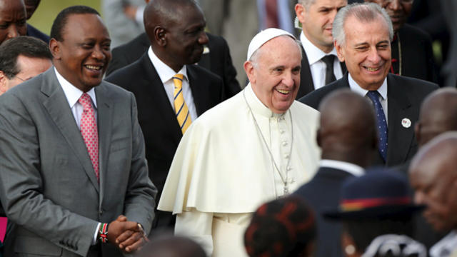 Pope Francis smiles as he walks next to Kenyan President Uhuru Kenyatta, left, in Nairobi, Kenya, Nov. 25, 2015. 