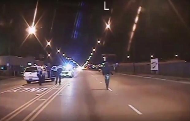 Laquan McDonald, right, walks on road before being shot 16 times by police officer Jason Van Dyke in Chicago, in still image taken from October 20, 2014 police vehicle dash camera video that was released by Chicago police on November 24, 2015. 