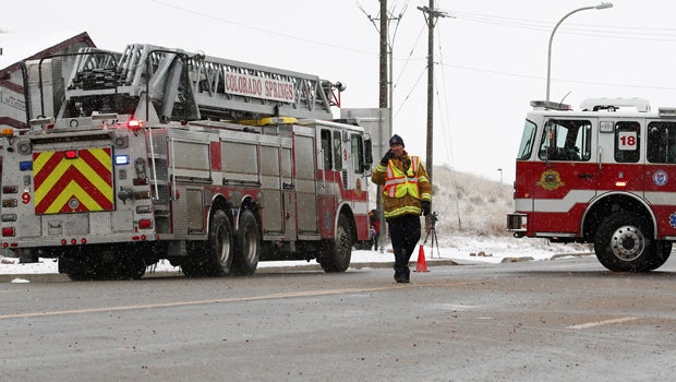Police officers secure a road leading to a Planned Parenthood center after reports of an active shooter in Colorado Springs, Colorado, Nov. 27, 2015.