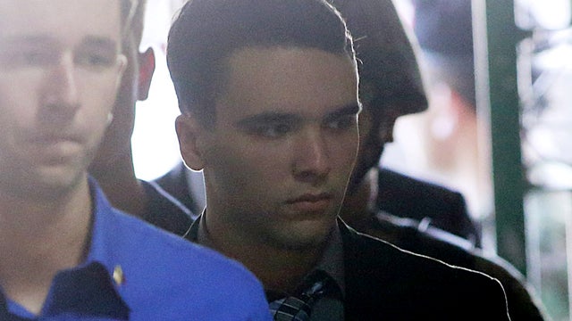 U.S. Marine Lance Corporal Joseph Scott Pemberton (right) is escorted into a court in Olongapo city, north of Manila, Philippines 